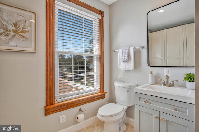 bathroom with tile patterned flooring, a healthy amount of sunlight, toilet, and baseboards