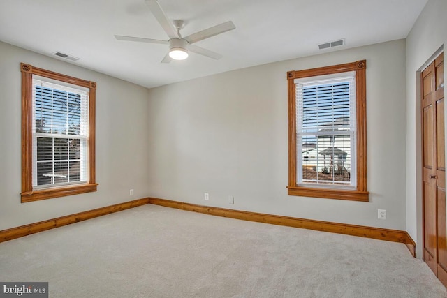 unfurnished bedroom with visible vents, baseboards, carpet, and a ceiling fan