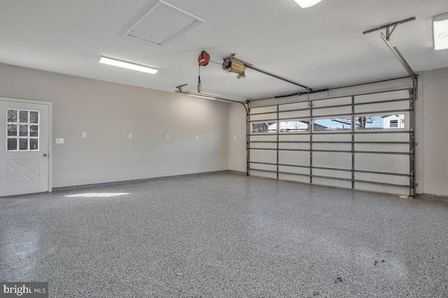 garage with a garage door opener and baseboards