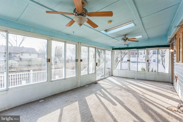 unfurnished sunroom with a skylight and a ceiling fan