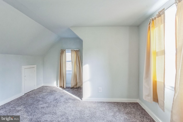 bonus room featuring vaulted ceiling, carpet, and baseboards