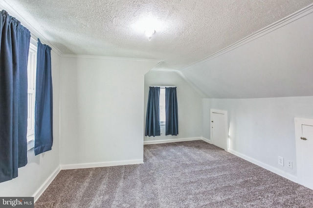 bonus room with vaulted ceiling, carpet, baseboards, and a textured ceiling