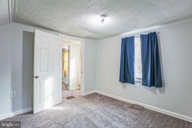 unfurnished bedroom featuring baseboards, carpet floors, and a textured ceiling