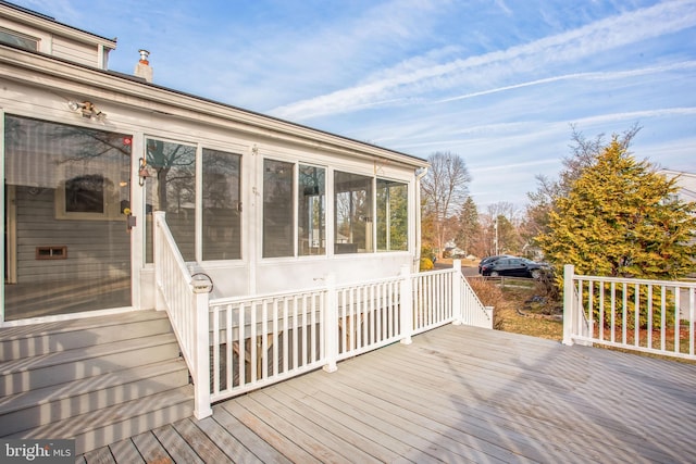 wooden deck featuring a sunroom