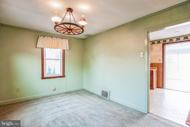 unfurnished room with visible vents, crown molding, baseboards, a chandelier, and carpet floors