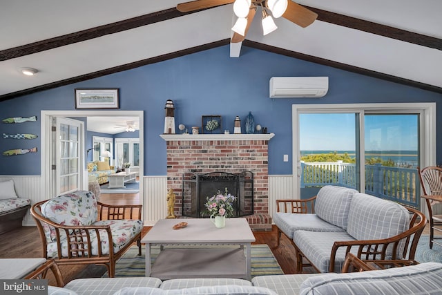 living area featuring a wainscoted wall, an AC wall unit, lofted ceiling with beams, wood finished floors, and a ceiling fan