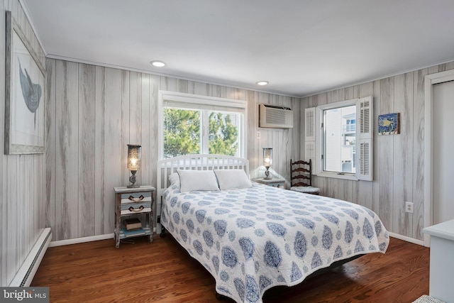 bedroom with a wall mounted AC, dark wood-style floors, recessed lighting, a baseboard radiator, and baseboards