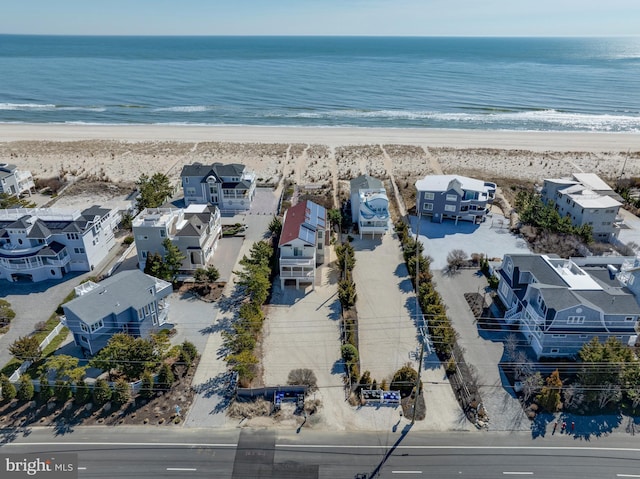 bird's eye view featuring a residential view, a water view, and a view of the beach