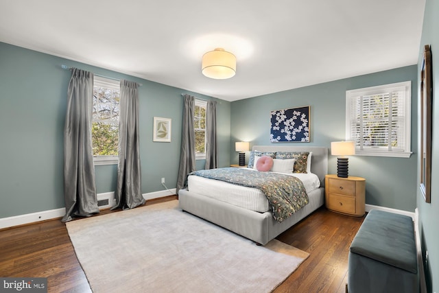 bedroom featuring baseboards and hardwood / wood-style flooring