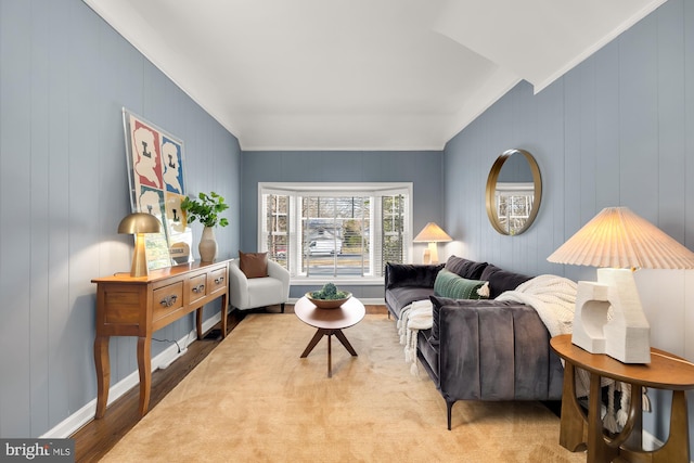 living room with baseboards, lofted ceiling, and wood finished floors