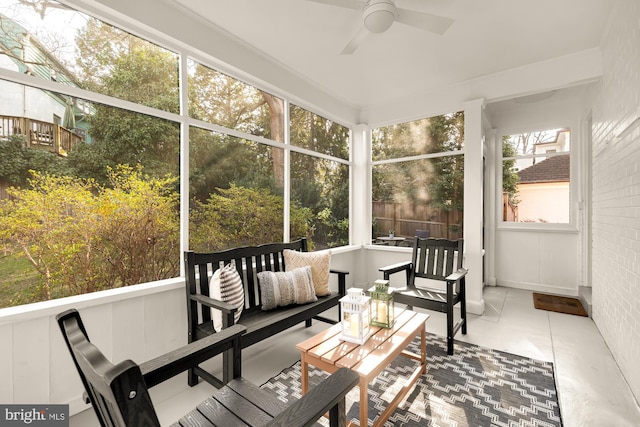 sunroom featuring ceiling fan