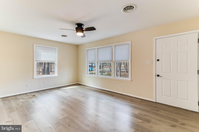 entryway featuring visible vents, wood finished floors, baseboards, and ceiling fan