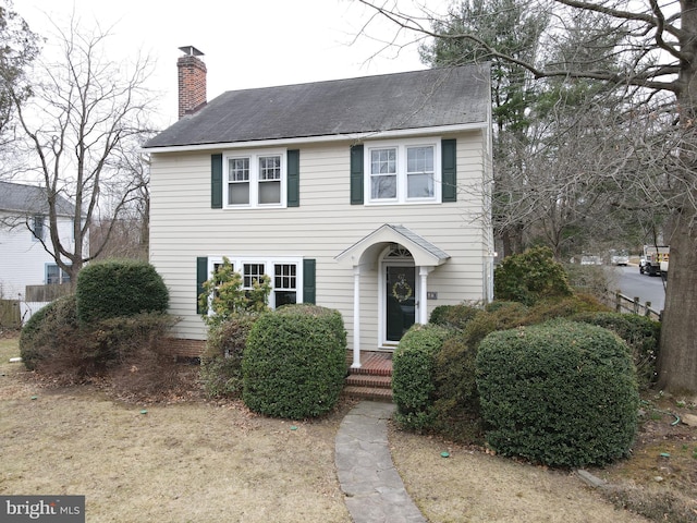 colonial inspired home with a chimney