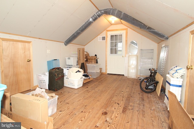 bonus room with visible vents, hardwood / wood-style floors, and vaulted ceiling