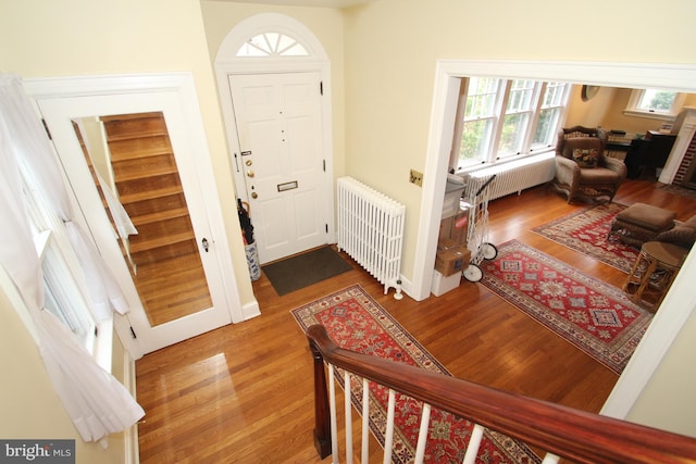 foyer with radiator and wood finished floors