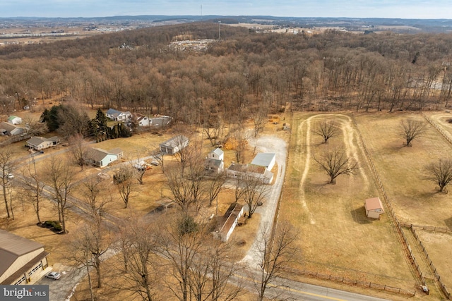 birds eye view of property featuring a wooded view