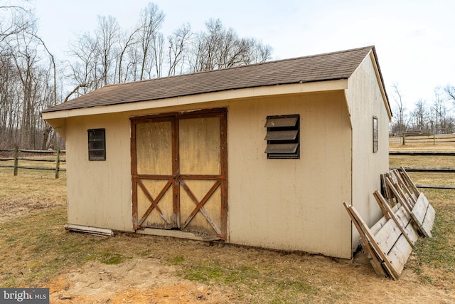 view of shed featuring fence