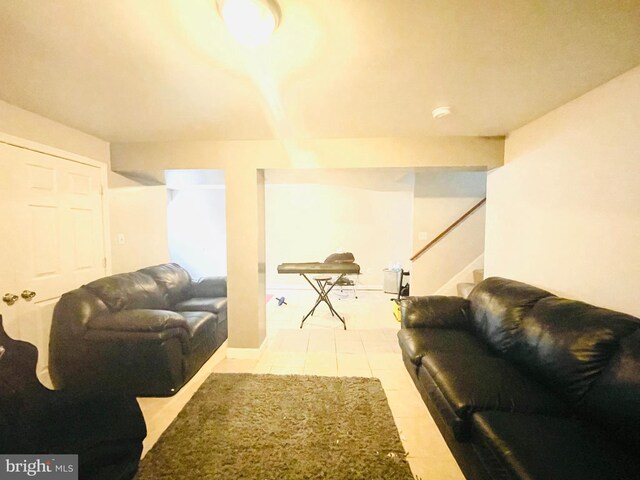 living area featuring tile patterned floors and stairway