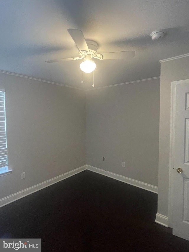 spare room featuring ornamental molding, baseboards, and ceiling fan