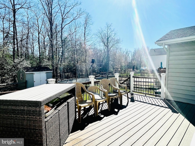 deck with a storage unit and an outbuilding