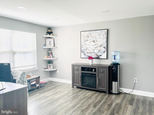 interior space featuring recessed lighting, baseboards, and wood finished floors