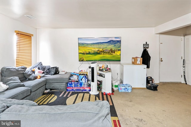 living area with concrete flooring