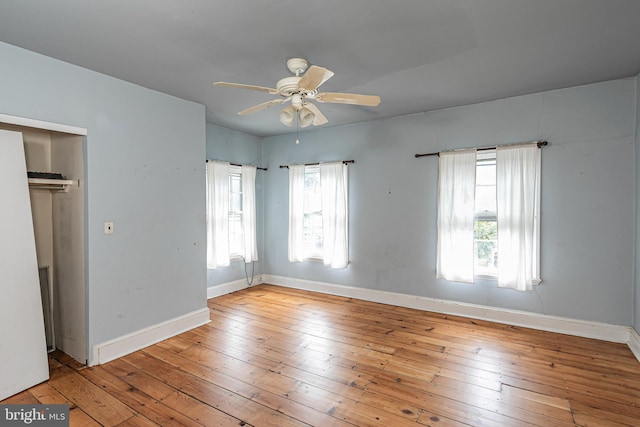 unfurnished bedroom featuring baseboards, wood-type flooring, and ceiling fan