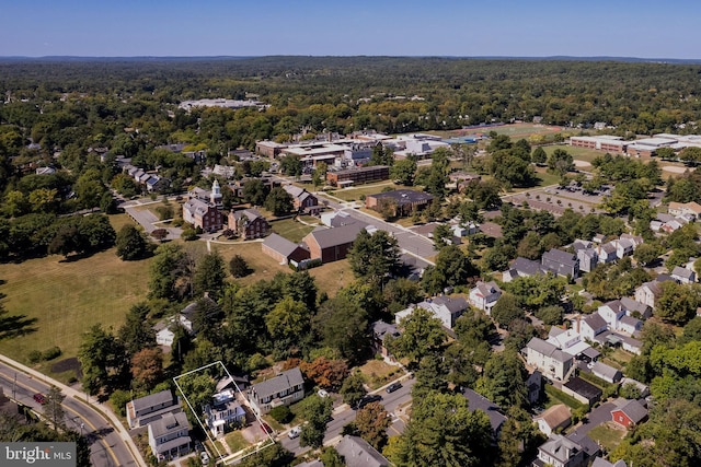 drone / aerial view with a residential view and a wooded view