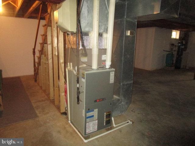 utility room featuring heating unit