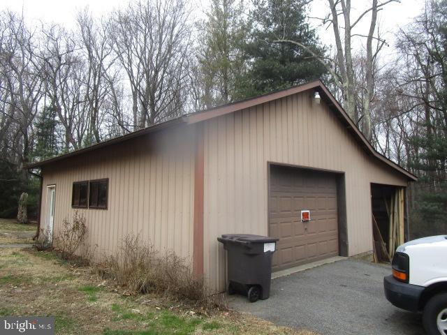 exterior space featuring an outbuilding and a garage