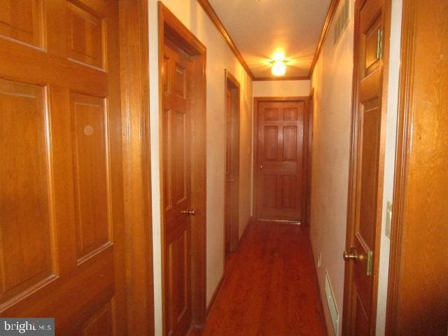 hallway featuring ornamental molding