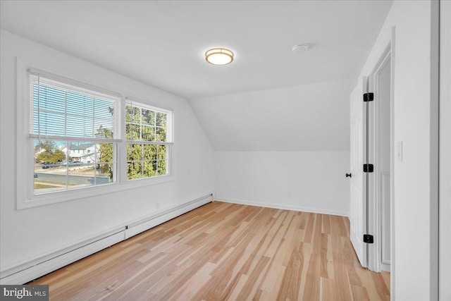 bonus room featuring baseboards, baseboard heating, vaulted ceiling, and light wood finished floors