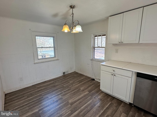 unfurnished dining area with dark wood finished floors, visible vents, crown molding, and a chandelier