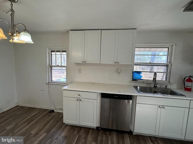 kitchen with dark wood-type flooring, light countertops, stainless steel dishwasher, white cabinets, and a sink