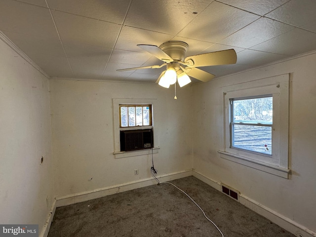 spare room featuring visible vents, plenty of natural light, baseboards, and carpet flooring