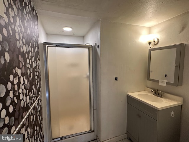 bathroom featuring vanity and a shower stall