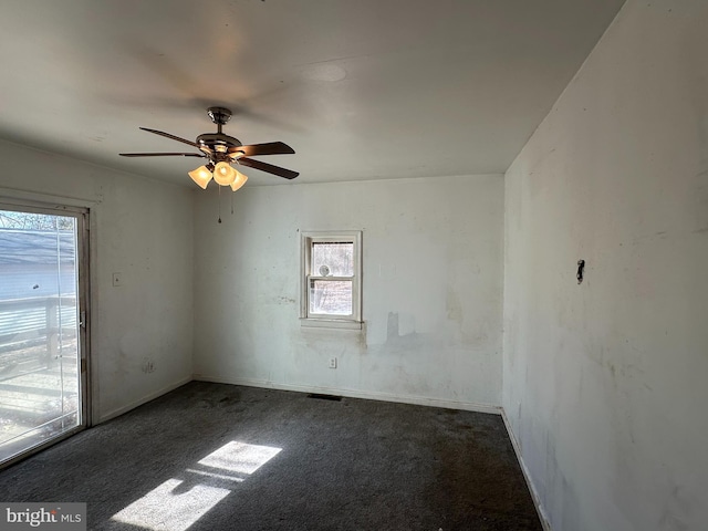 empty room featuring visible vents, carpet floors, baseboards, and ceiling fan