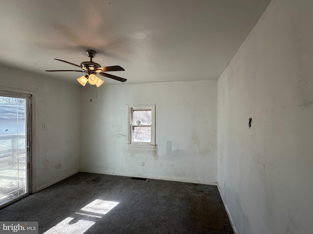 empty room featuring carpet flooring, baseboards, and ceiling fan