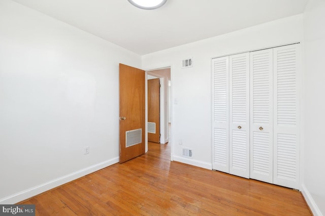 unfurnished bedroom featuring light wood-type flooring, visible vents, and baseboards