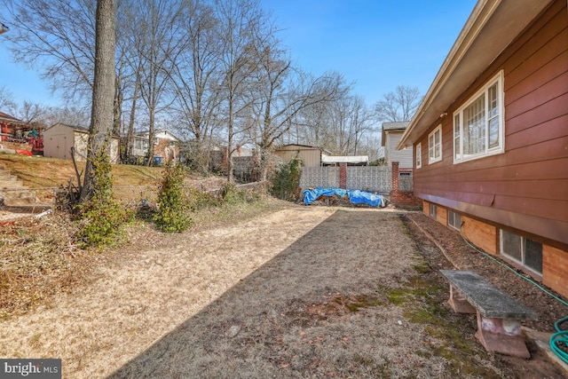 view of yard featuring an outbuilding and a storage unit