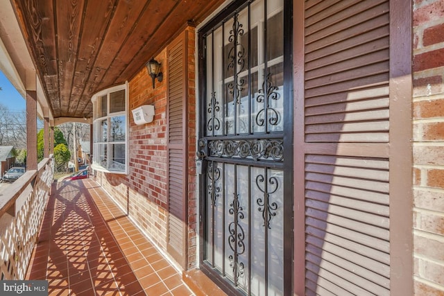 doorway to property featuring brick siding