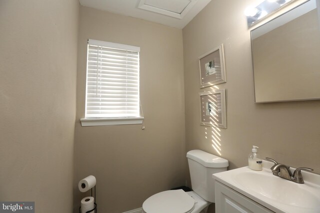 half bath featuring toilet and vanity