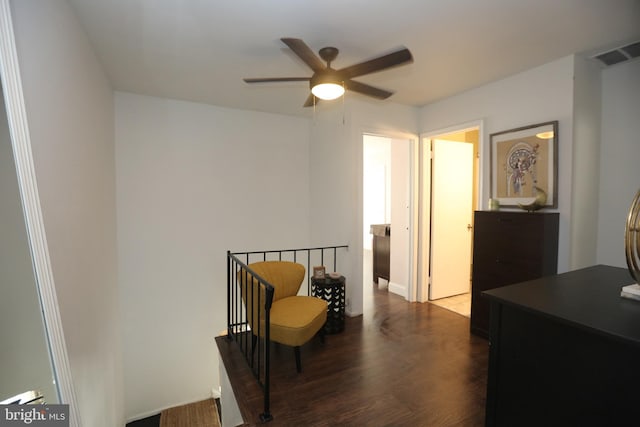 bedroom featuring a ceiling fan, visible vents, and dark wood-style flooring