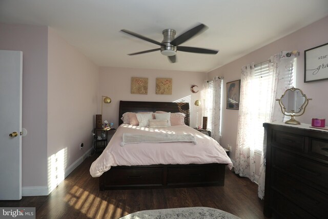 bedroom with visible vents, wood finished floors, baseboards, and ceiling fan