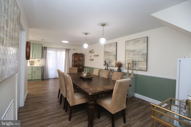 dining area with visible vents, baseboards, and dark wood-style floors