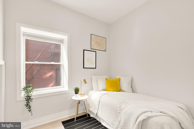 bedroom with wood finished floors and baseboards