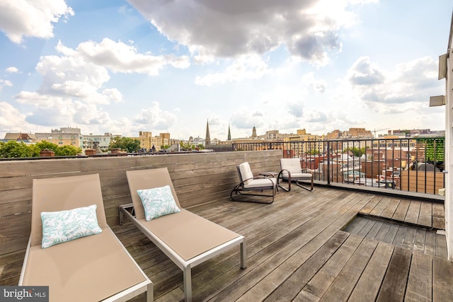 wooden terrace featuring a city view