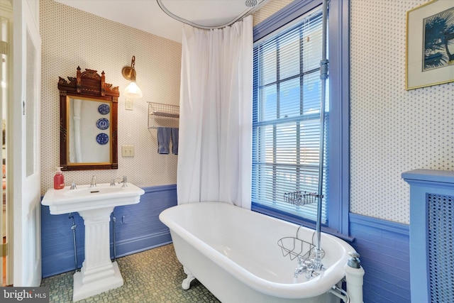 full bathroom featuring tile patterned floors, tile walls, wainscoting, wallpapered walls, and a freestanding bath