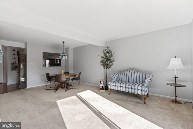 living area with carpet flooring and baseboards