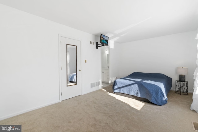 carpeted bedroom featuring visible vents